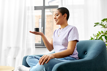 Image showing african american woman with smart speaker at home