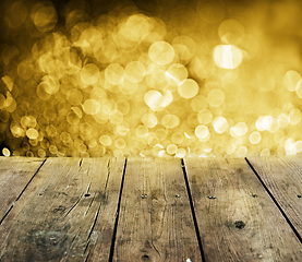 Image showing Wooden table with golden lights