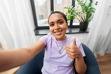 Image showing happy african american woman taking selfie at home