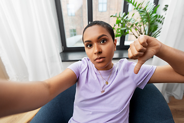 Image showing woman taking selfie and showing thumbs down