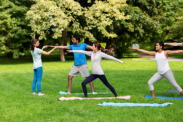 Image showing group of people doing yoga at summer park