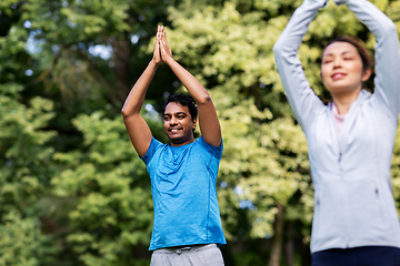 Image showing group of people doing yoga at summer park