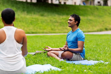 Image showing group of people doing yoga at summer park