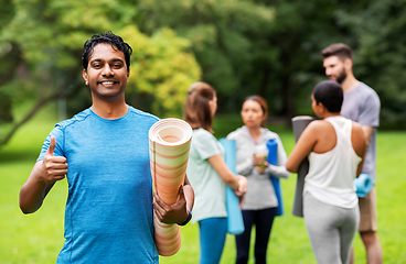 Image showing smiling indian man with yoga mat showing thumbs up