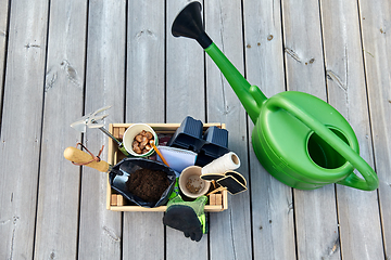 Image showing box with garden tools and watering can in summer