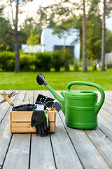 Image showing box with garden tools and watering can in summer