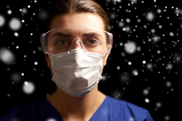 Image showing female doctor or nurse in goggles and face mask