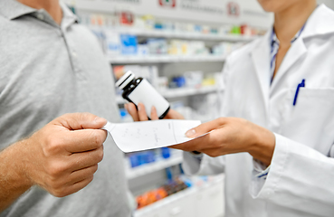 Image showing pharmacist and customer with medicine at pharmacy