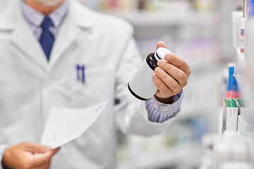 Image showing close up of pharmacist with medicine at pharmacy