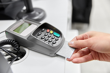 Image showing close up of hand with credit card in card-reader