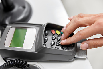 Image showing close up of hand with credit card in card-reader