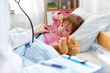 Image showing doctor with stethoscope and sick girl in bed