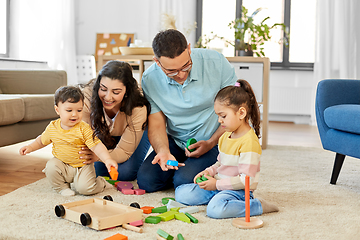 Image showing happy family palying with wooden toys at home