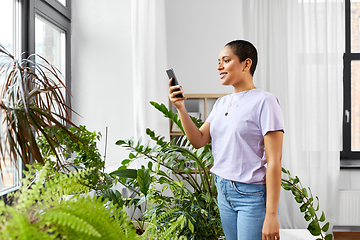 Image showing african american woman with smartphone at home