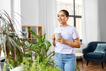 Image showing african american woman drinking coffee at home