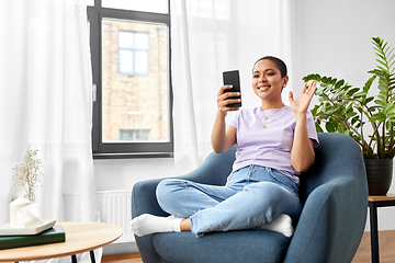 Image showing woman with smartphone having video call at home