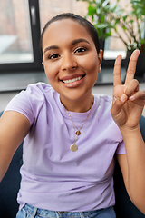 Image showing happy african american woman taking selfie at home