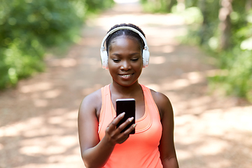 Image showing african american woman with headphones and phone