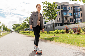 Image showing teenage boy on skateboard on city street