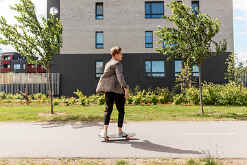 Image showing teenage boy on skateboard on city street