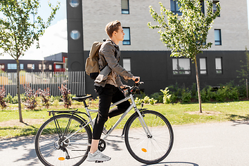 Image showing young man riding bicycle on city street