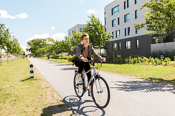 Image showing young man riding bicycle on city street