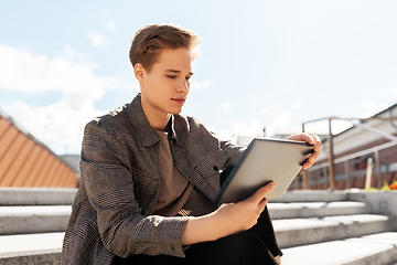 Image showing young manor teenage boy with tablet pc in city