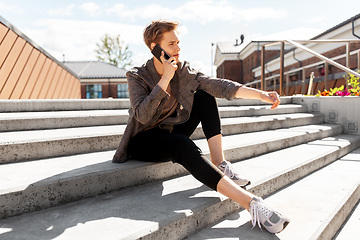 Image showing teenage boy calling on smartphone in city