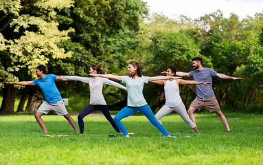 Image showing group of people doing yoga at summer park