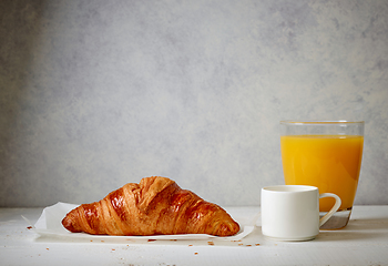 Image showing freshly baked croissant, espresso and juice