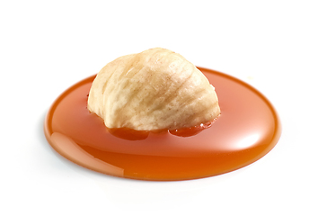 Image showing hazelnut in melted caramel drop