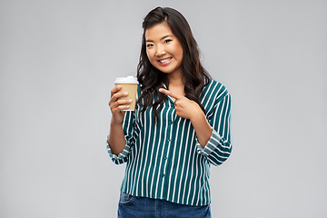 Image showing happy asian woman showing takeaway coffee cup