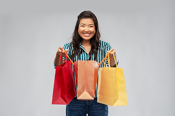 Image showing happy asian woman with shopping bags