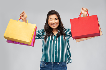 Image showing happy asian woman with shopping bags