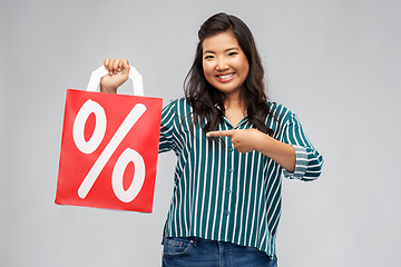 Image showing asian woman with percentage sign on shopping bags