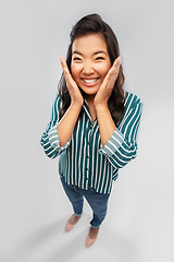 Image showing happy asian woman over grey background