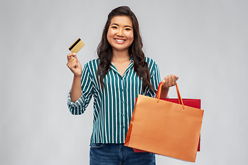 Image showing asian woman with shopping bags and credit card