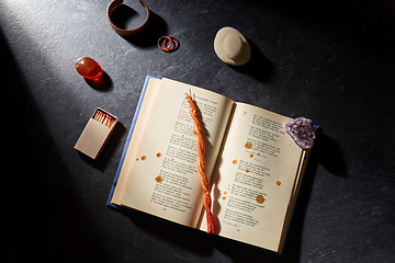 Image showing magic book, wax candle, matches and gem stones