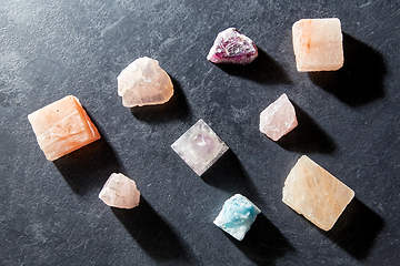 Image showing quartz crystal pyramid and gem stones on slate