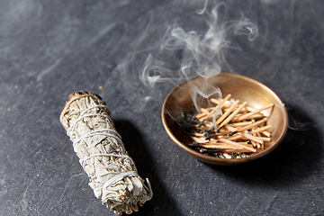 Image showing white sage and cup with smoking matches