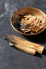 Image showing palo santo sticks and cup with burnt matches