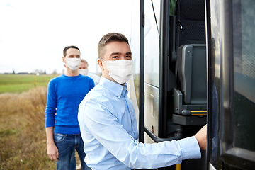 Image showing group of passengers in masks boarding travel bus