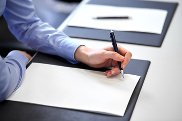 Image showing close up of businesswoman with paper at office