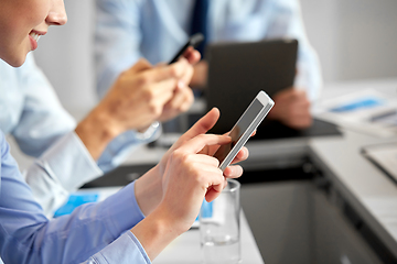 Image showing close up of businesswoman with smartphone