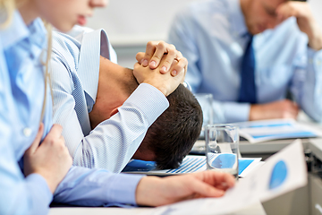 Image showing stressed business people on conference at office