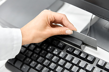 Image showing close up of pharmacist's hand swiping credit card