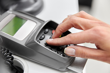 Image showing close up of hand with credit card in card-reader