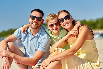 Image showing happy family hugging on summer beach