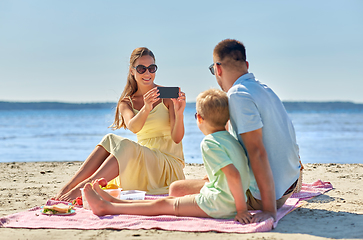 Image showing family with smartphone photographing on beach