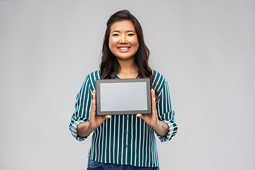 Image showing happy asian woman using tablet computer